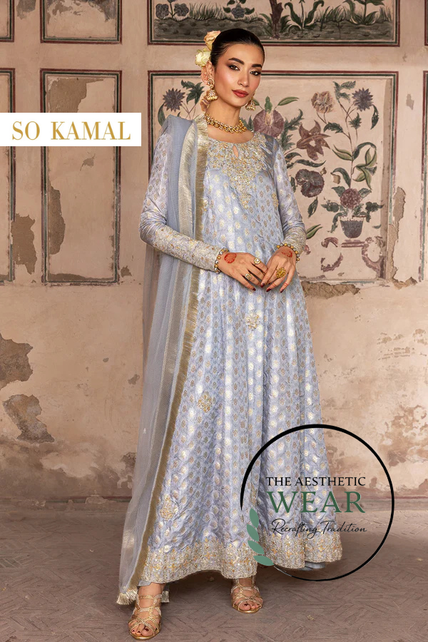 Ice blue zari jamawar suit featuring intricate embroidery and embellishments, styled elegantly with a dupatta.